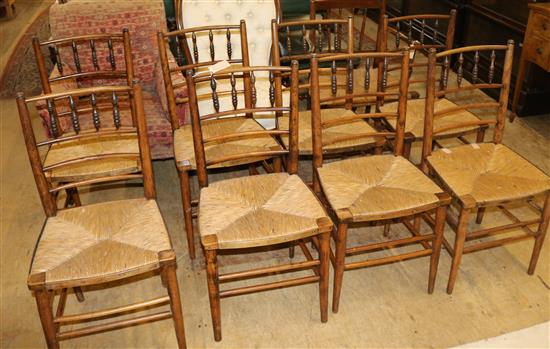 Set of eight rush-seat spindle back chairs and a similar armchair